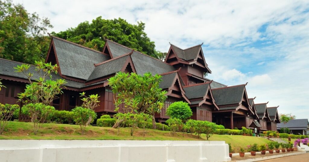 The beautiful, intricate brown wooden architecture of the Muzium Istana Sultanate Palace Museum stretching across the photo in Melaka, Malaysia