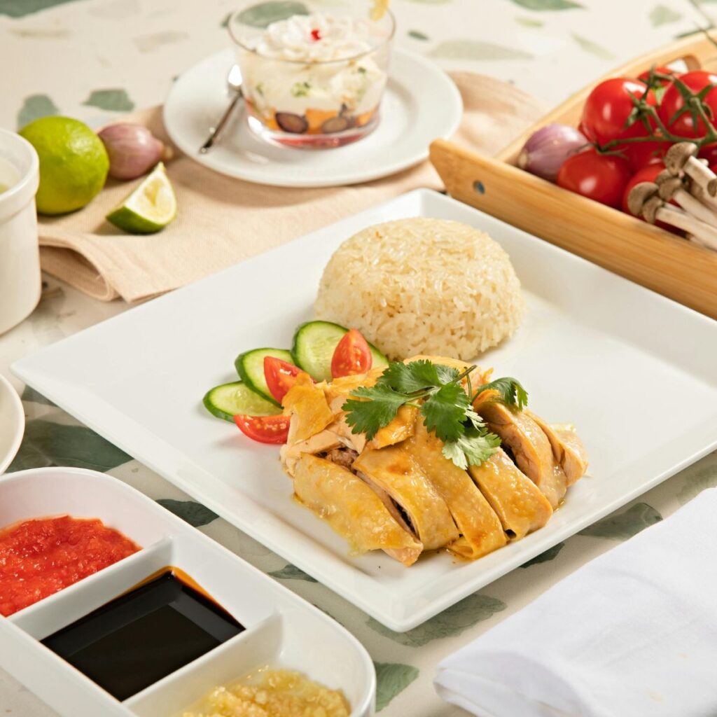 authentic Singaporean Hainanese chicken rice served with fresh ginger and chili dipping sauces.