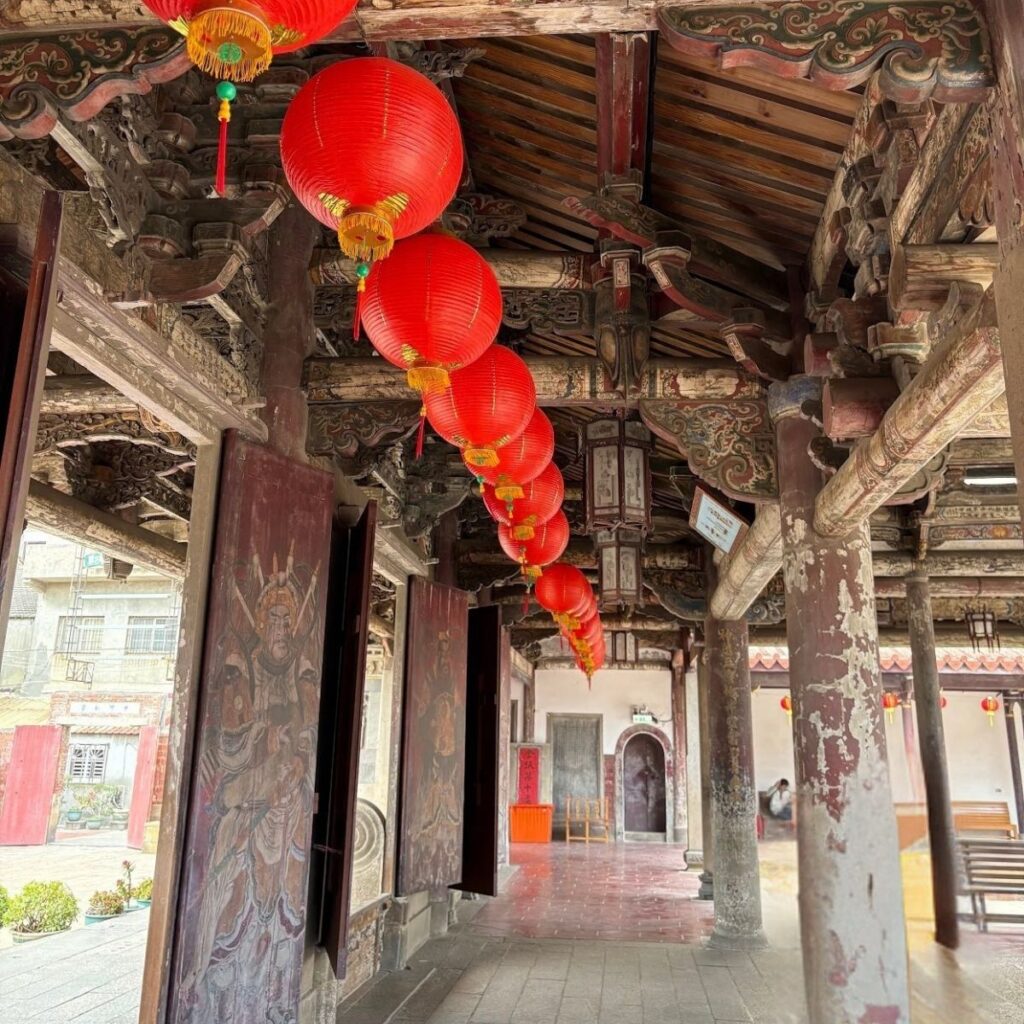 Traditional lanterns hanging over the roof beams inside the historic Lukang Temple entrance.