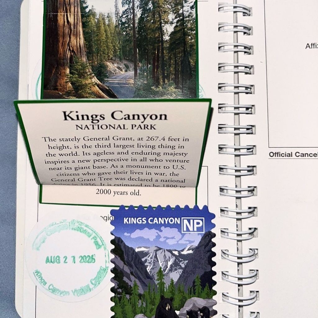 A spiral-bound passport journal showing an official green and blue circular Kings Canyon National Park ink cancellation stamp dated August 27, 2026.